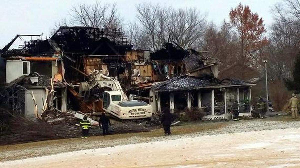 
Workers on Monday began clearing the back side of this house in the 500 block of West 123rd Terrace after a Sunday night fire left it too unsafe for investigators to enter. Susan Herrera, 31, died and a Kansas City fire captain, Charlie Cashen, was injured in the blaze.
