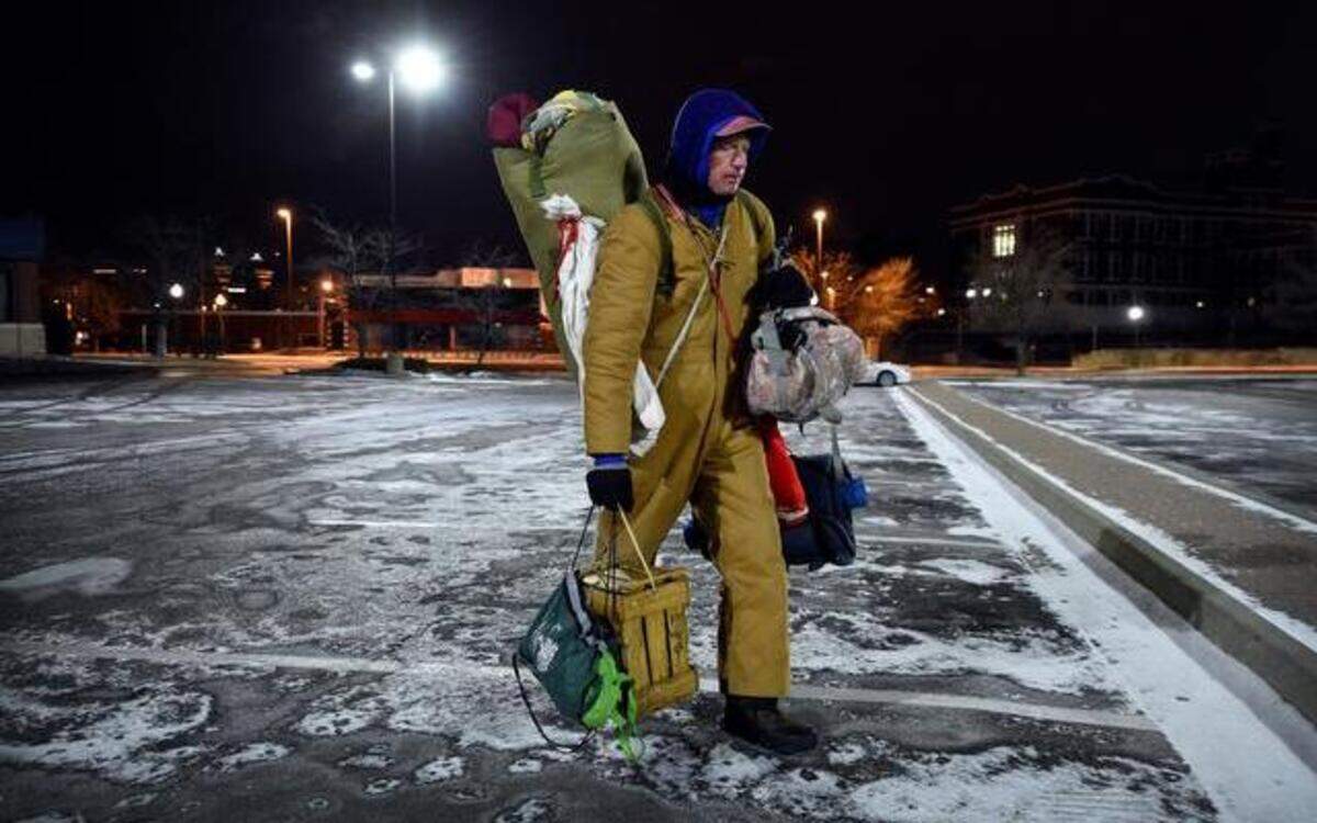 
After spending Tuesday night outside, Joel Hinson, who is homeless, gathered his belongings and made his way to a grocery store in Westport, where he can warm up. Hinson said he dresses in layers and when he can get them, uses hand-warmers in his socks to stay as warm as he can overnight.
