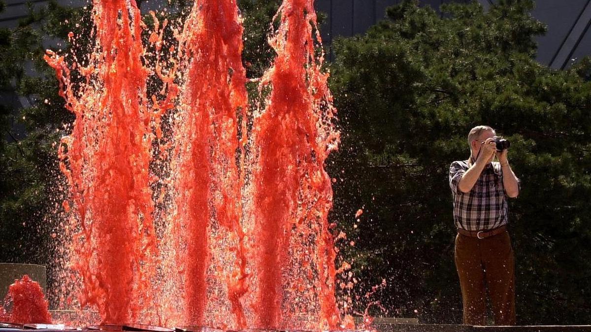 It is a years-long tradition to dye fountains around Kansas City red to celebrate important Kansas City Chiefs games, such as a 2000 Monday night football game at Arrowhead, being photographed here by a fan. Buffalo Bills fans are mocking the tradition ahead of the AFC Championship game.