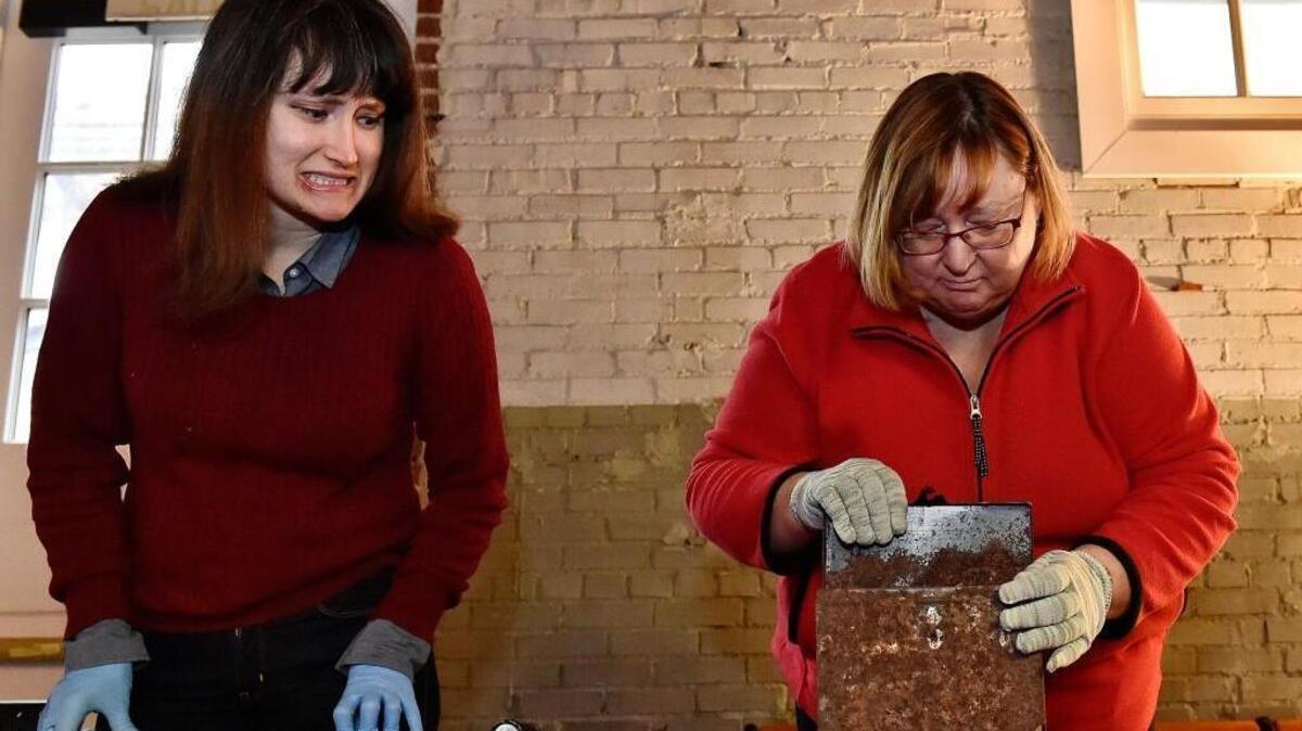 A small box discovered in the cornerstone of the recently demolished Thacher School in Kansas City was opened and its contents revealed Saturday at the Kansas City Musuem. Kate Warfield, collections specialist at the Kansas City Museum, grimaced as colleague Denise Morrison, director of curatorial services and collections, opened the fragile container.