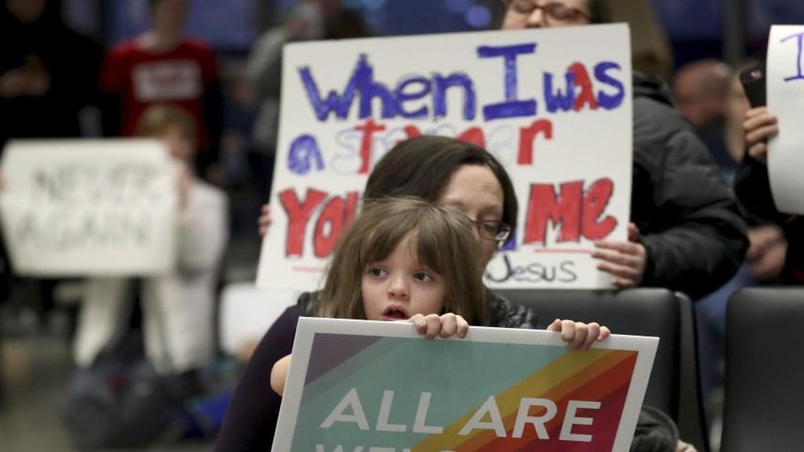 Rachel Walker of St. Paul and her daughter Evelyn, 7, joined others in protesting an executive order signed by President Donald Trump restricting immigration from several Muslim nations Saturday at the Minneapolis-St. Paul International Airport.
