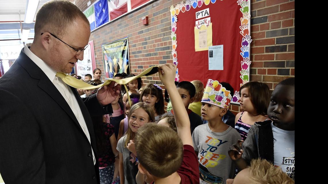 
Wednesday marked the start of year-round school for students at Crestview Elementary and Winnwood Elementary in the North Kansas City School District. On their first day, students at Crestview Elementary review correct procedures for such things as lining up and moving through the hallways. While they wait to go into the cafeteria, one student took an interest in Principal Deyrle  Wallace's tie.
