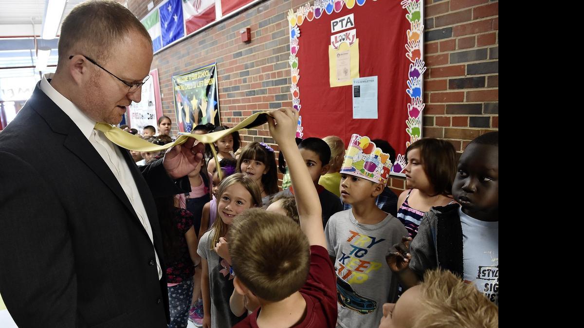 
Wednesday marked the start of year-round school for students at Crestview Elementary and Winnwood Elementary in the North Kansas City School District. On their first day, students at Crestview Elementary review correct procedures for such things as lining up and moving through the hallways. While they wait to go into the cafeteria, one student took an interest in Principal Deyrle  Wallace's tie.
