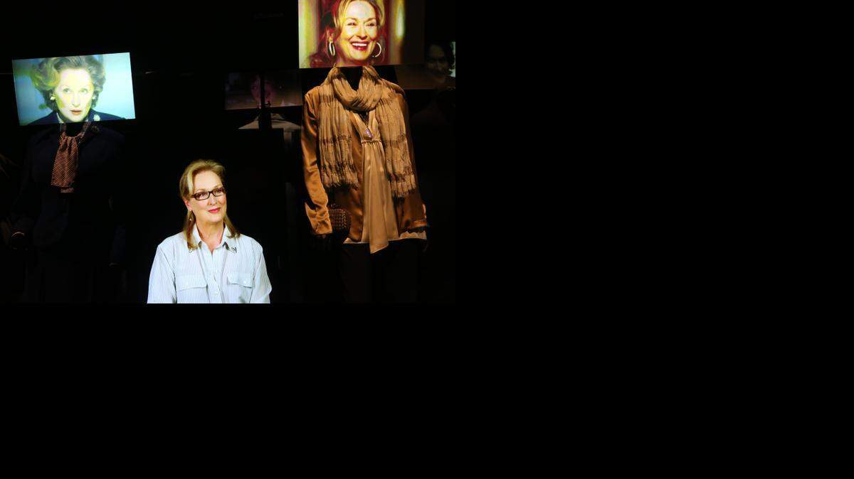 
Actress Meryl Streep has said “What makes you different or weird — that’s your strength.” Here she is surrounded by screen images and costumes from some of her roles at the “Hollywood Costume” exhibition last month in Los Angeles. 
