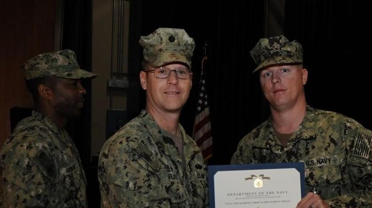 Navy Equipment Operator Daniel Sellmeyer (right) is awarded the Navy and Marine Corps Achievement Medal for helping to save a man trapped in a car in an icy creek in Mississippi.