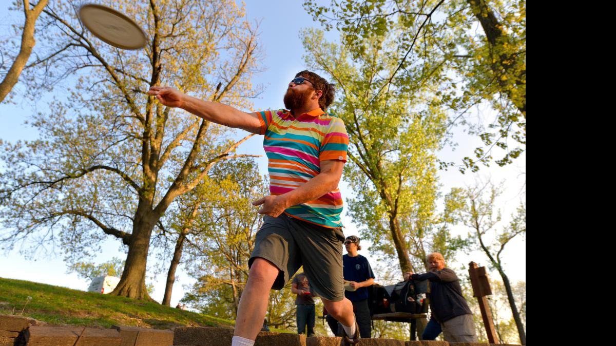 
Kansas City Flying Disc Club member Mike Fenton lets his disc fly on a drive during league play at the Waterworks Park.
