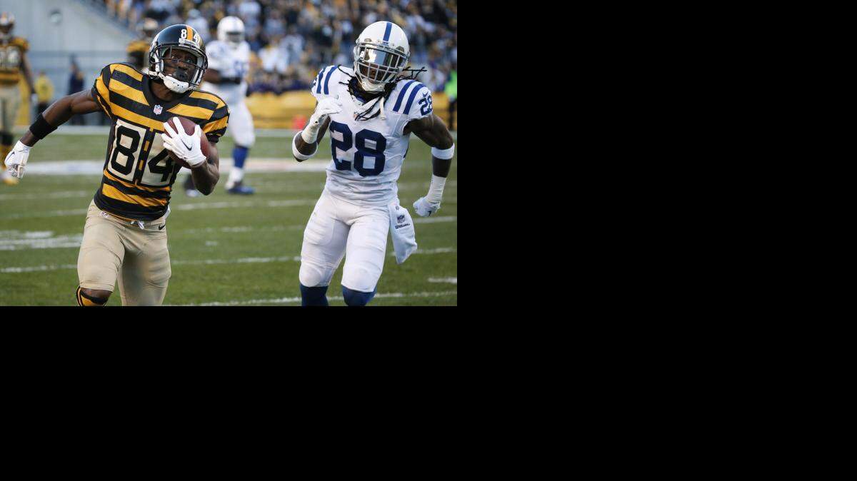 
Pittsburgh Steelers wide receiver Antonio Brown (84) runs past Indianapolis Colts cornerback Greg Toler (28) after making a catch in the first half of the NFL football gameagainst the Indianapolis Colts, Sunday, Oct. 26, 2014 in Pittsburgh. 
