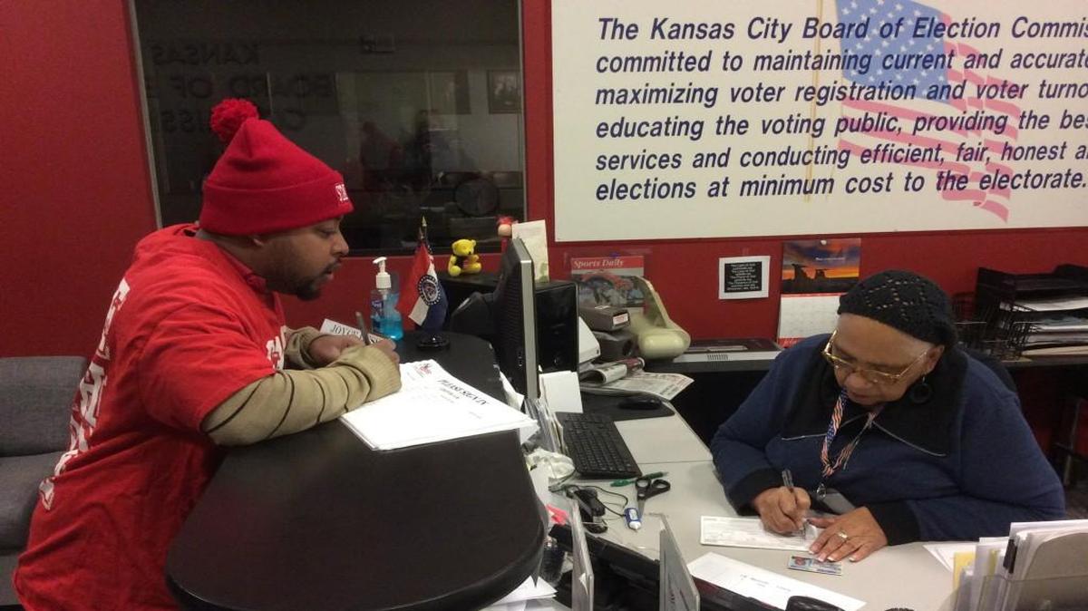 Motivated by the Fight for $15 wage campaign for low-wage workers, Michael Hayes, 29, registered as a voter Thursday at the Kansas City election board. Election board worker Joyce Bess assisted his registration.