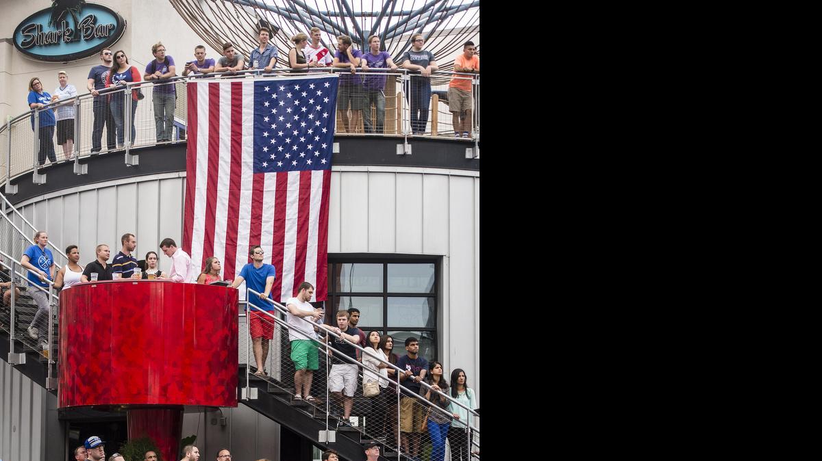 
A large U.S. flag is displayed on Tuesday, June 30, 2015, as fans watch the U.S. soccer team's match against Germany in the Women's World Cup semifinals televised at the Power & Light District in downtown Kansas City. The U.S. women beat Germany 2-0.
