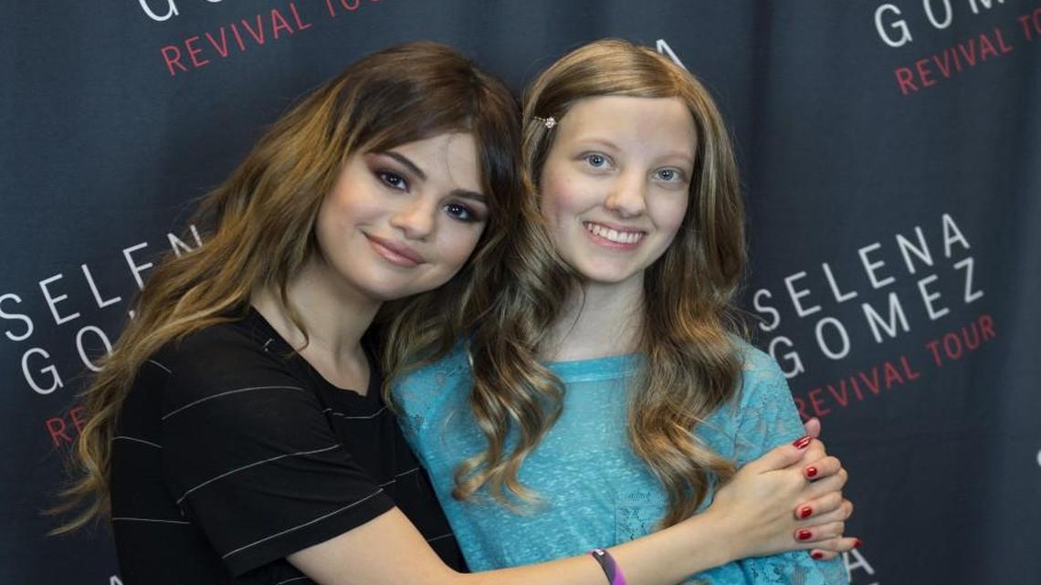 Alayna Shelley (right), who is fighting leukemia, was pleased to get a hug from singer Selena Gomez backstage before the start of Friday’s concert at the Sprint Center. The Hudson Project provided a limo ride to the concert and the concert tickets.