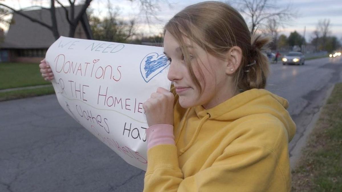 A teen held up a sign asking for food or clothing donations in Olathe to help the homeless. In Springfield, the City Council recently voted to make it illegal to give to those in need through vehicle windows.