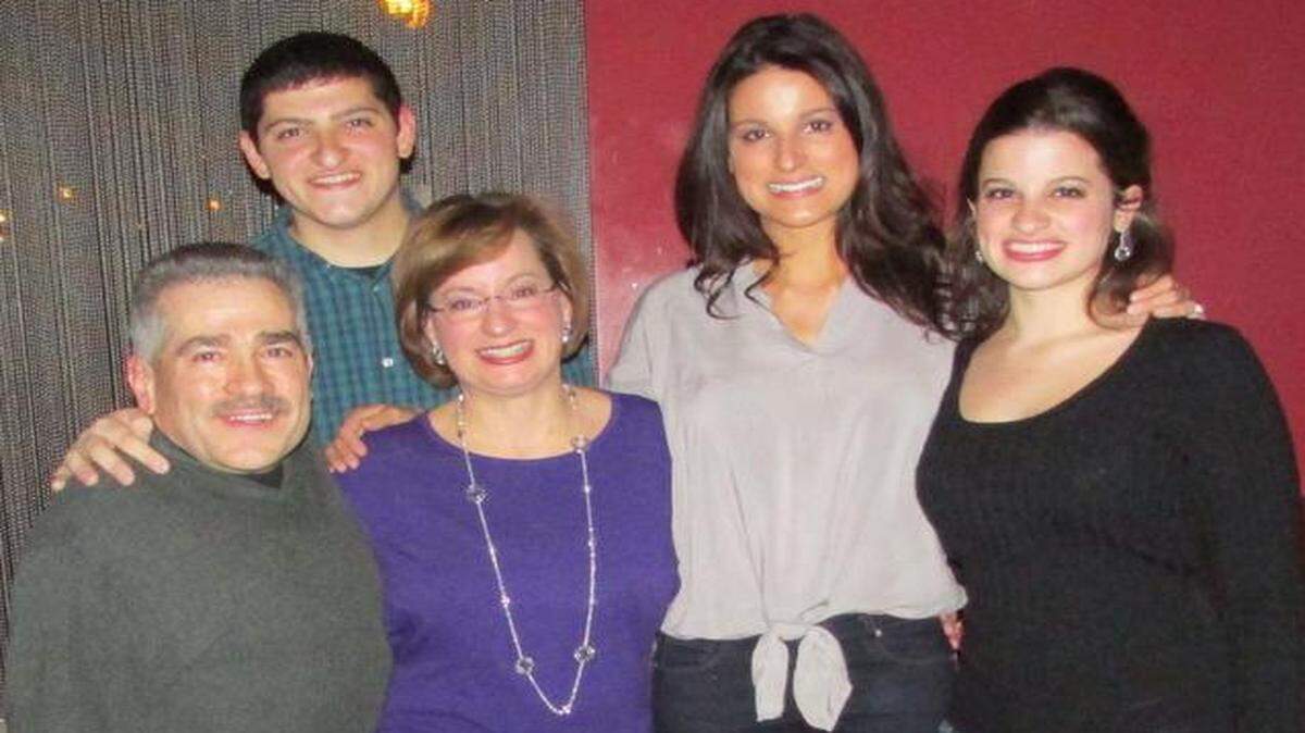 
This is the only photo of the entire LaManno family: Jim and Terri (together, front left), son Gian, and daughters Jen and Alissa (right).
