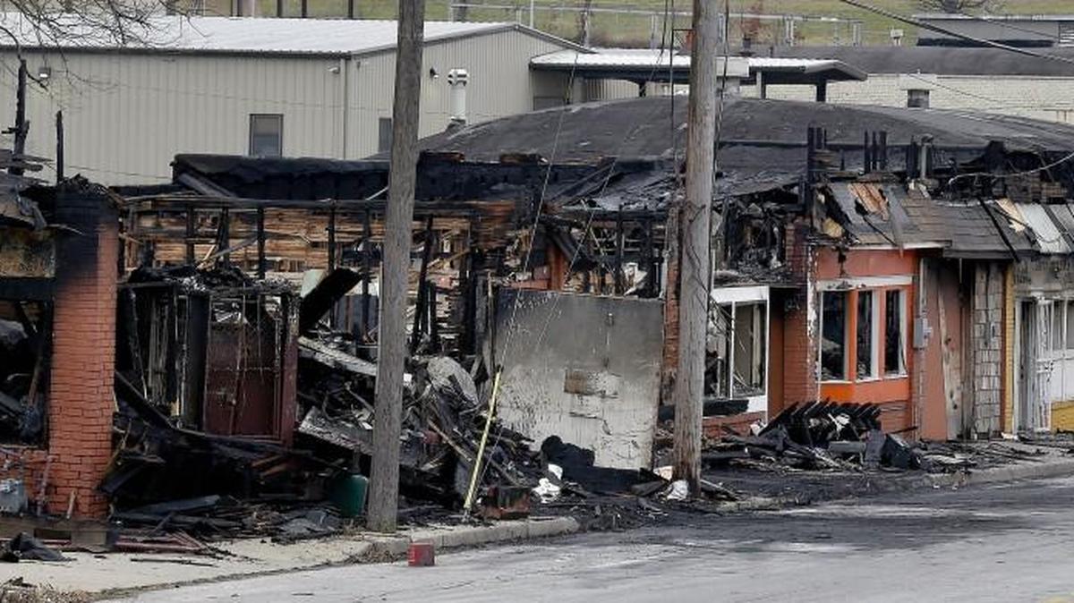 The burned-out row of buildings on Sunday, December 20, 2015, where the body of a man was found after the Kansas City Fire Department extinguished a blaze on Saturday night along 18th Street between Monroe and Cleveland avenues in Kansas City, Mo.