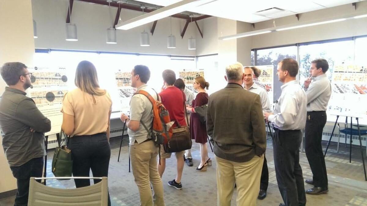 Visitors at the Mid-America Regional Council Tuesday ponder ideas on display for public input for a possible complete remake of the Interstate 70 North Loop and the Buck O’Neil Bridge in downtown Kansas City. The survey is available online at www.beyondtheloopkc.org.