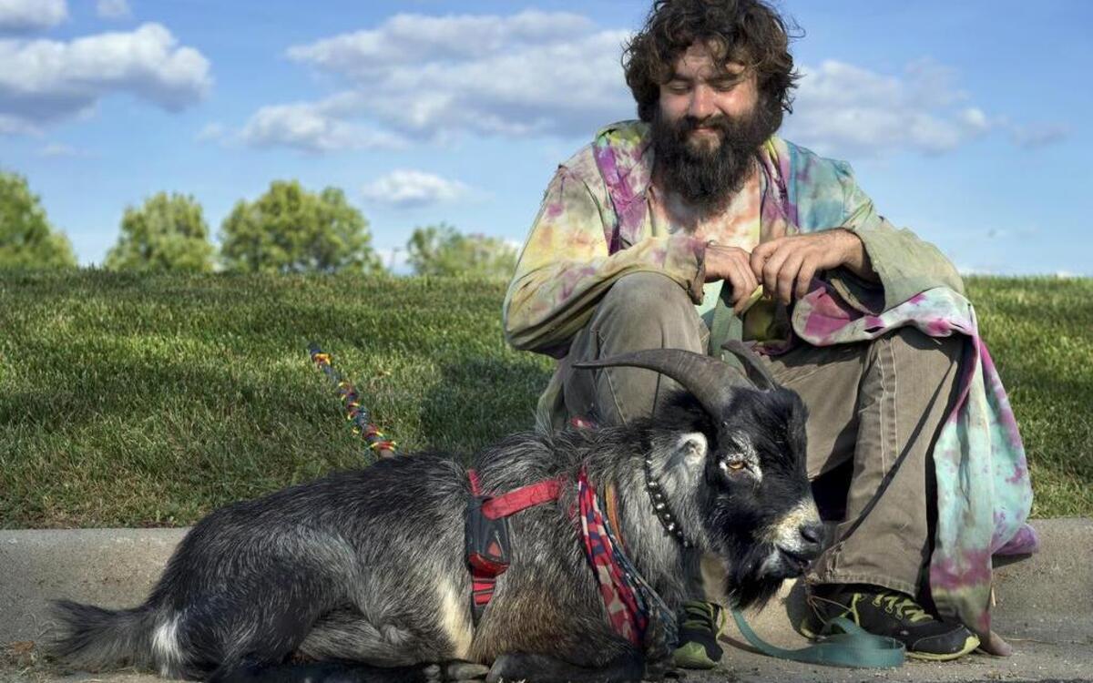 In this 2015 photo, Erick Brown and his goat were traveling the country spreading “peace and love” and hoping to inspire people to live their dreams. They were pictured here in Independence.
