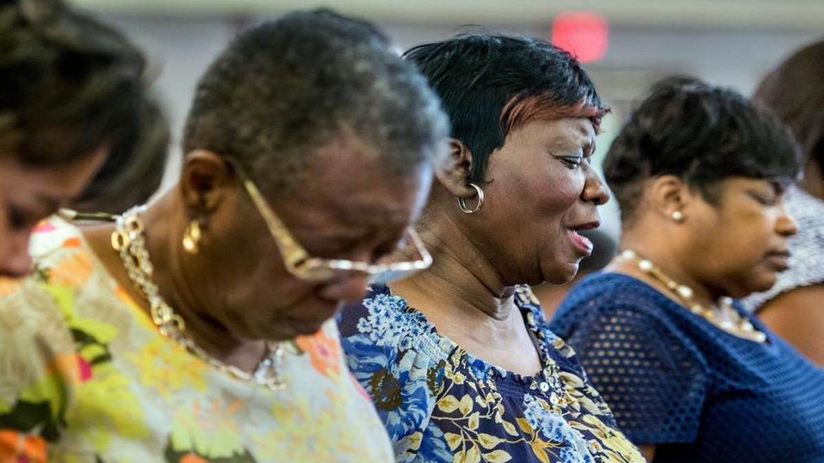 
Nell Redmond (third from left) prayed during Saturday’s service at Mount Zion Baptist Church in Kansas City, Kan. The prayer service was to remember the nine people killed in a church shooting Wednesday in Charleston, S.C.
