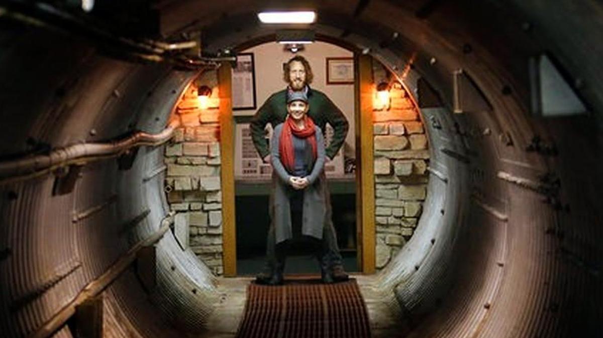 Mathew Fulkerson and his wife Leigh Ann pose at their Subterra Airbnb located in a former underground missile silo base near Eskridge, Kan. The Subterra Castle Airbnb opened for business about six months ago