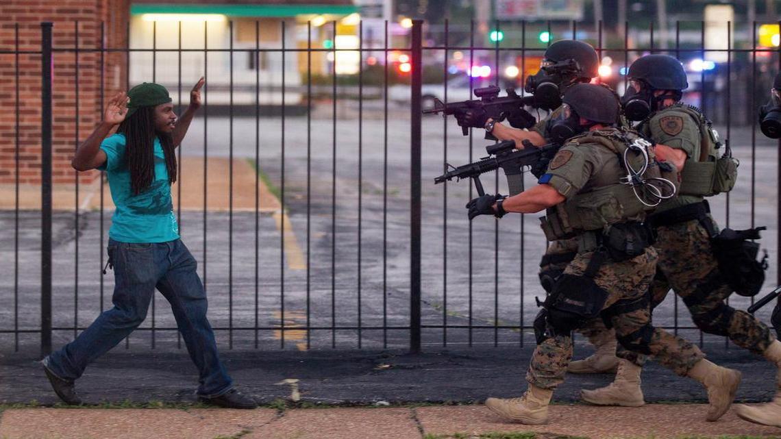 
On Aug. 11, 2014, in Ferguson, Mo., a man backed away as law enforcement officials closed in on him and eventually detained him during protests over the death of Michael Brown, an unarmed black teenager killed by a white police officer.
