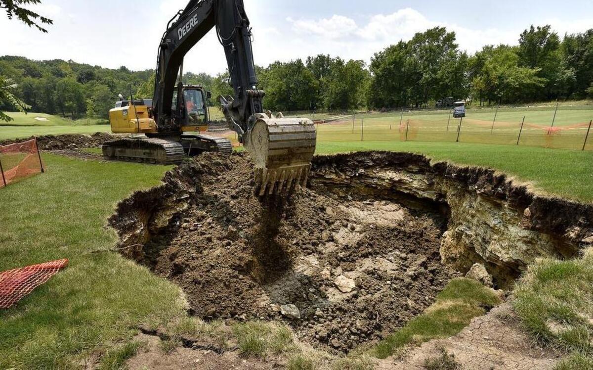 
After a sink hole swallowed part of the fairway on the 13th hole of the Canyon Farms Golf Club in Johnson County, a crew was on hand Monday afternoon dumping dirt into the void. The golf club is located at 18145 W. 87th St. in Lenexa.
