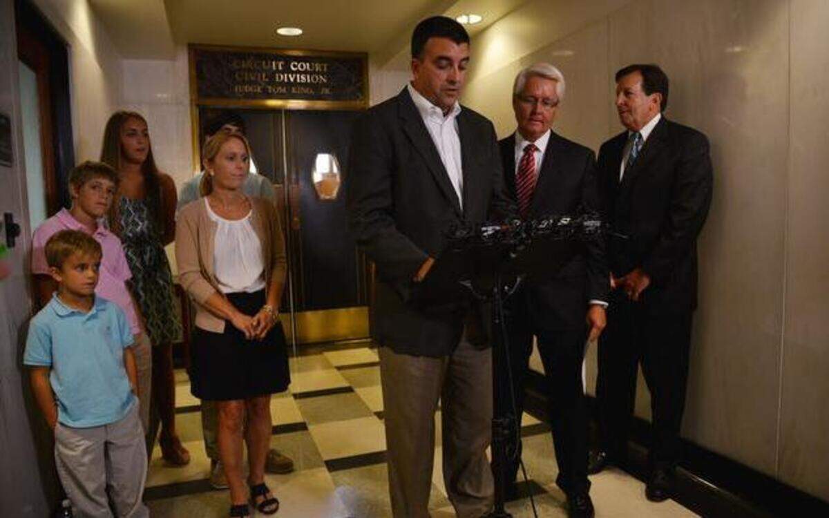 
Ryan Bresette (center) of Overland Park read a statement Wednesday at the Jefferson County Courthouse in Alabama after his family reached a legal settlement with contractors who worked on a renovation project at the Birmingham-Shuttlesworth International Airport. Bresette’s son Luke,10, died on March 22, 2013, when a multi-user flight information display fell on him and several of his family members. 
