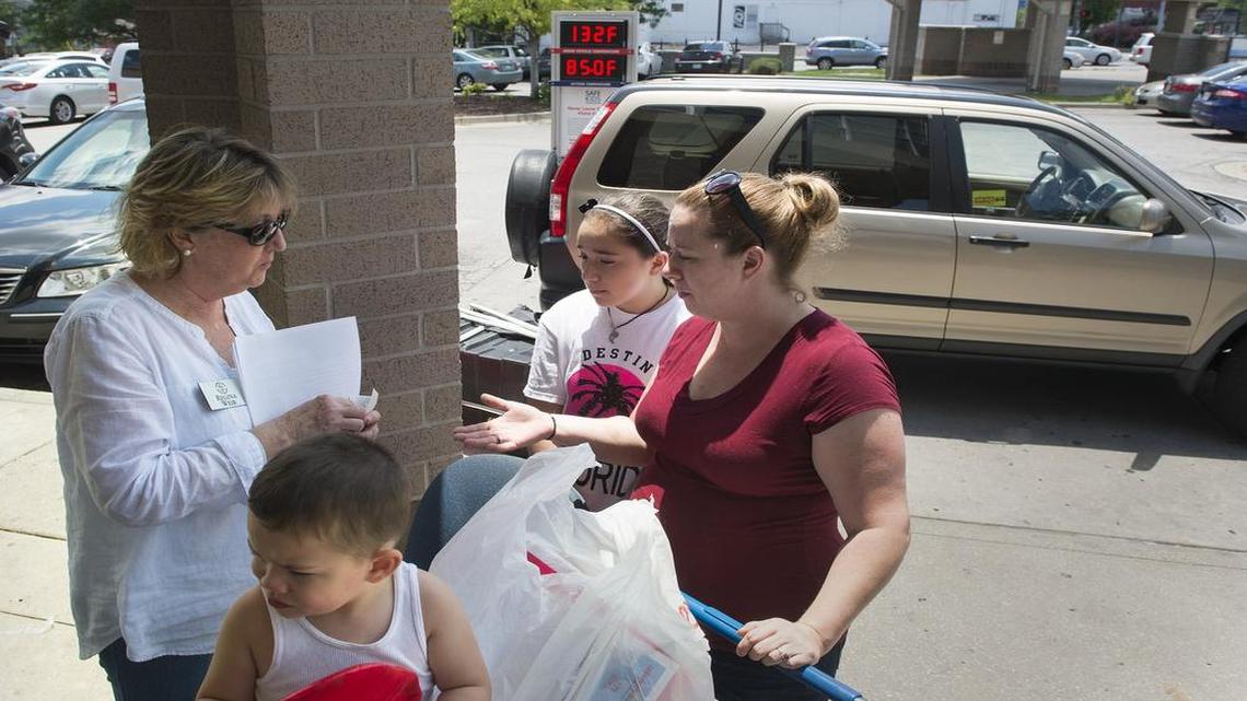 
On Saturday in midtown, Regina Weir (left) of Safe Kids Metro Kansas City spoke with Janelle Stevens (right), mother of Gianna Coronado, 11, and Andre, 2.


