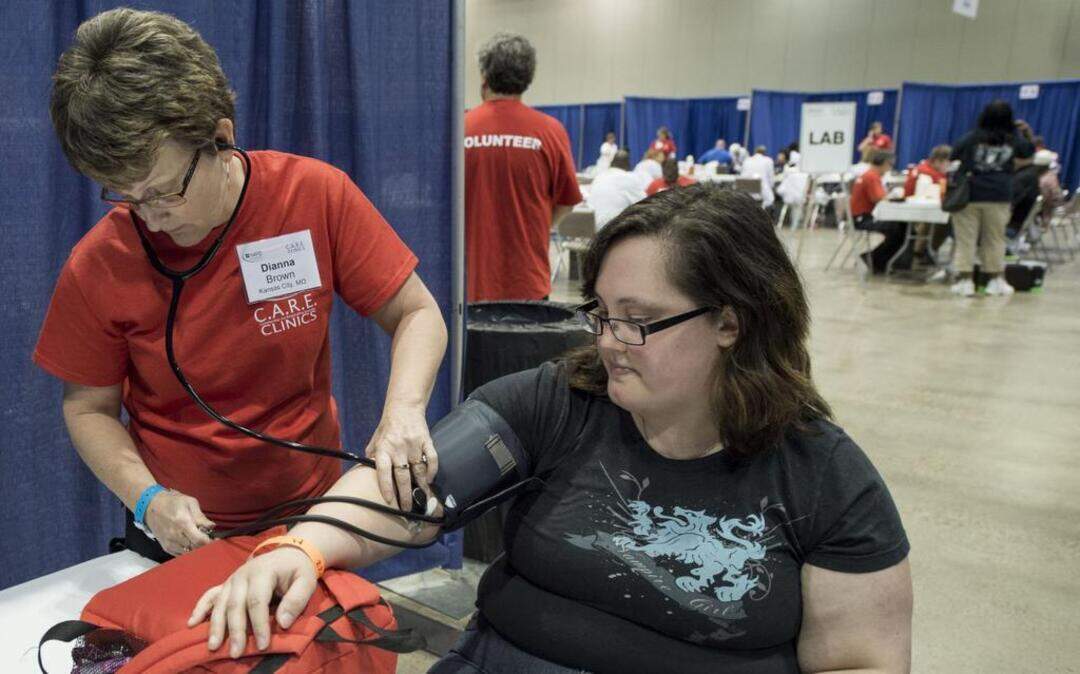 
Dianna Brown of Kansas City checked the blood pressure of Kira Roby of Kearney during Saturday’s free medical clinic at Bartle Hall.
