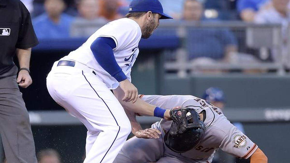
Kansas City Royals third baseman Mike Moustakas (8) gets the ball in time to tag out San Francisco Giants' Hunter Pence (8) at third on a single by Pablo Sandoval in the third inning during Friday's baseball game on August 8, 2014 at Kauffman Stadium in Kansas City, Mo. Pence was called safe, but a challenge by the Royals reversed the call.
