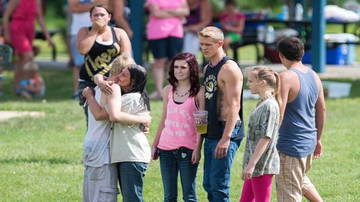 
Bystanders sought comfort from one another Saturday after the body of Tim J. Nolen, 18, was recovered.
