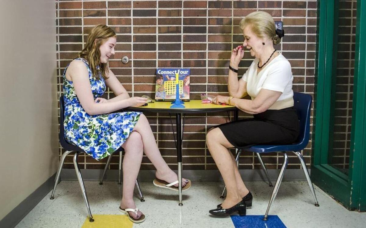 
Chloe Huston, 18, and Marilyn Duve played Connect Four recently where they first met at Mill Creek Elementary School in Independence, when Huston was in third grade. Huston graduated from William Chrisman High School this year thanks in part to Duve’s help and guidance over 10 years through the Independence School District’s mentoring program.
