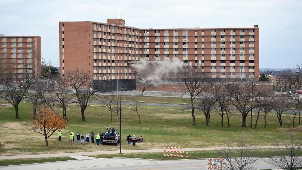 A series of photos captures McCollum Hall, a former residence hall on the campus of the University of Kansas, being imploded Wednesday.