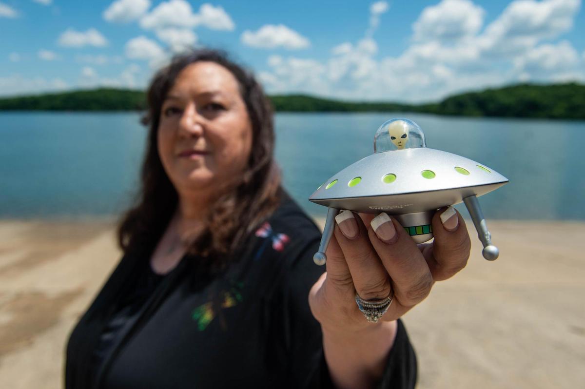 Margie Kay holds a UFO toy at Lake Jacomo, which she says is a hot spot for UFO sightings. Kay is the assistant director of the Missouri chapter of the Mutual UFO Network (MUFON).