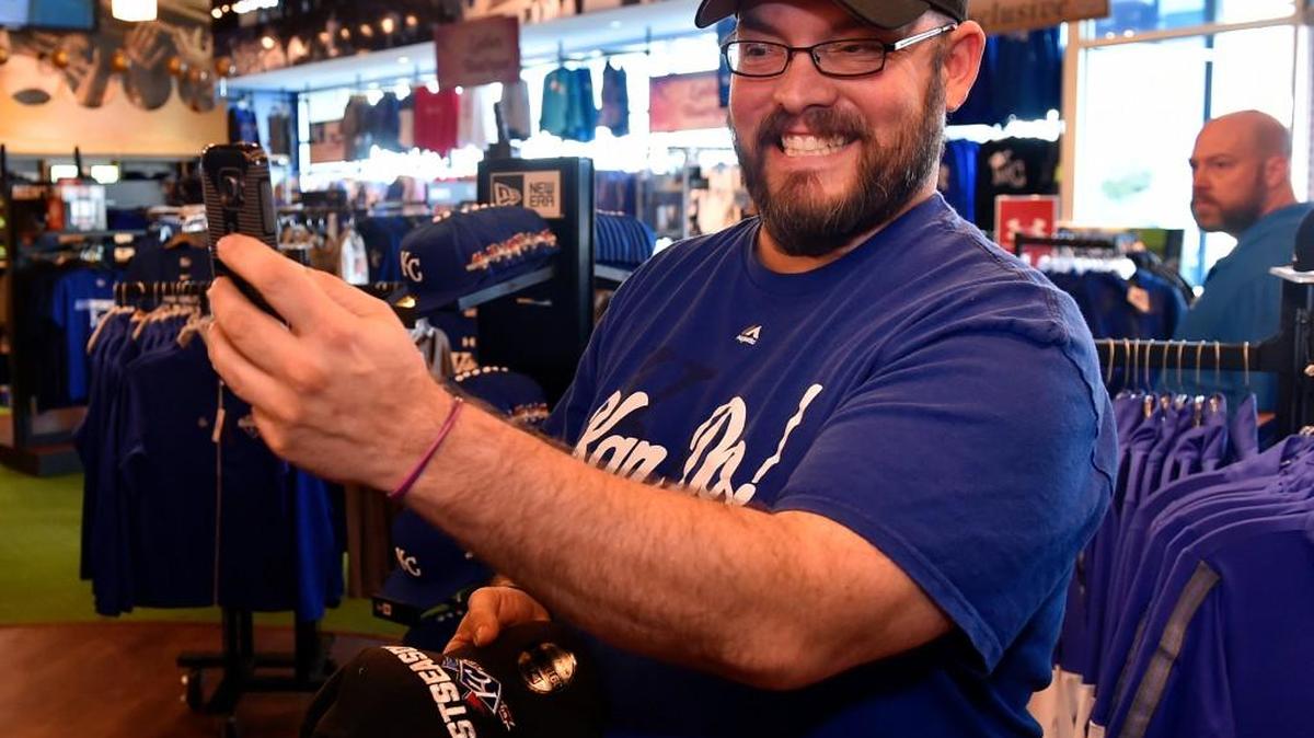 
Mike Orlando of Kansas City shot a selfie of himself wearing a cap at Kauffman Stadium Friday morning as fans browsed merchandise on display after the Royals clinched the AL Central Division.
