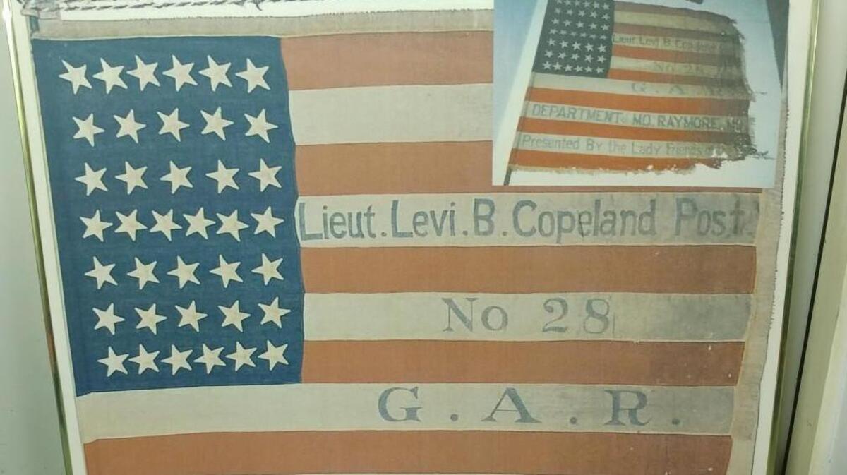 A flag carried by the Grand Army of the Republic is one of Raymore Historical Society’s most valued artifacts. The Grand Army of the Republic (GAR) was a fraternal organization composed of veterans of the Union Army and Navy, the Marines, and the United States Revenue Cutter Service who served in the Civil War.