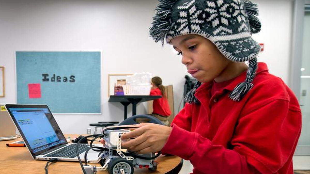 
Markail Taylor, 10, worked on a robotic vehicle Tuesday in Crossroads Academy’s new building at 1011 Central St. The new space includes classrooms, a science lab, visual and performing arts studios and study rooms, and is an expansion from the academy’s original building at 1015 Central St. The expansion was dedicated Wednesday.
