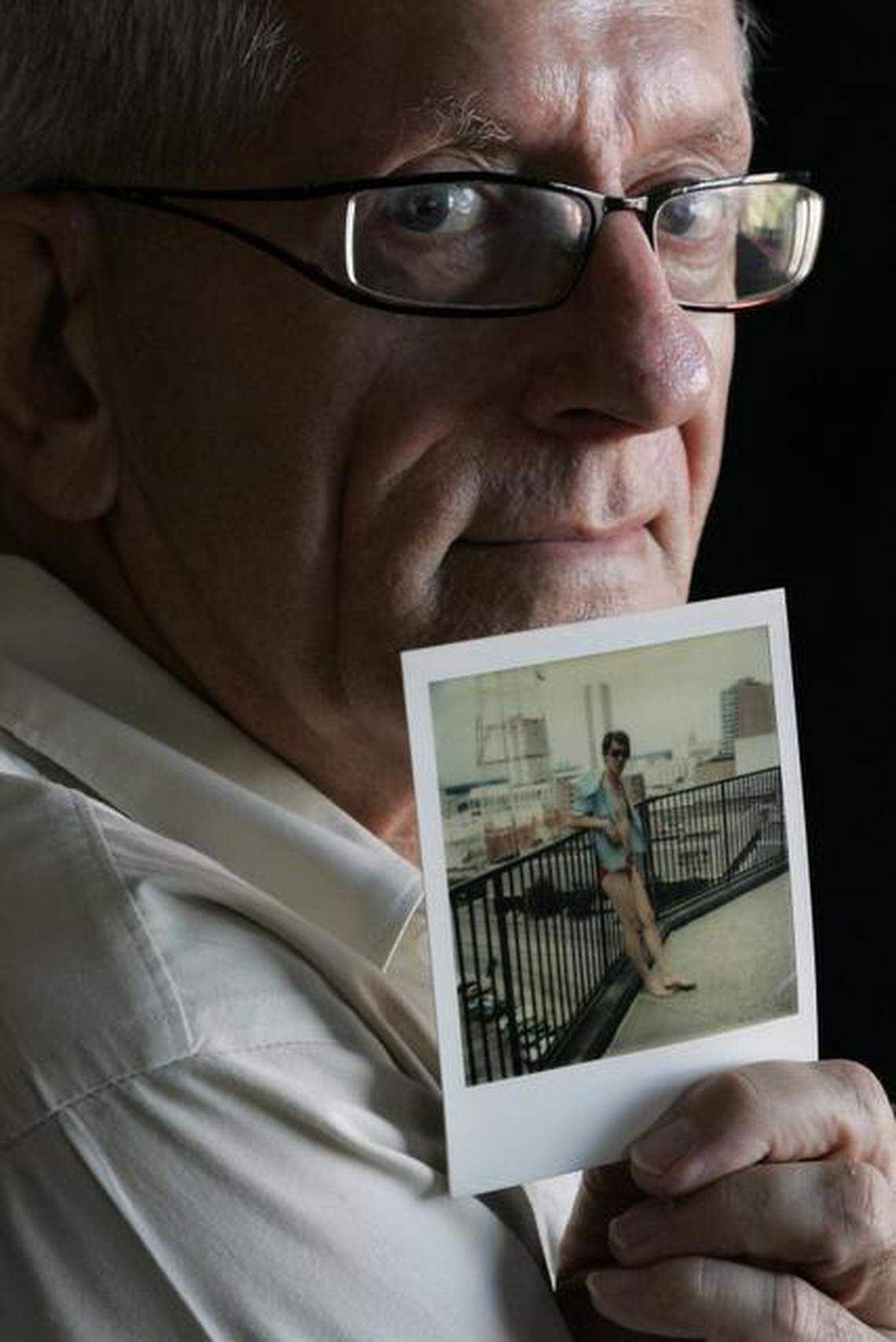 Frank Freeman, who was seriously during the Hyatt collapse. He holds a picture of his partner, Roger Grigsby who was killed that day.