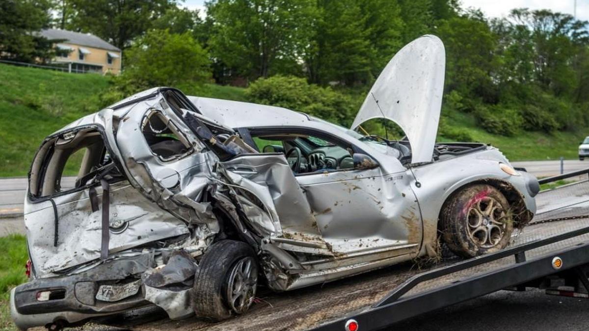 Authorities work the scene of a wreck Monday on northbound Interstate 435 near the Gregory Boulevard in Kansas City. A 19-year-old woman who was driving the PT Cruiser was taken to a hospital.