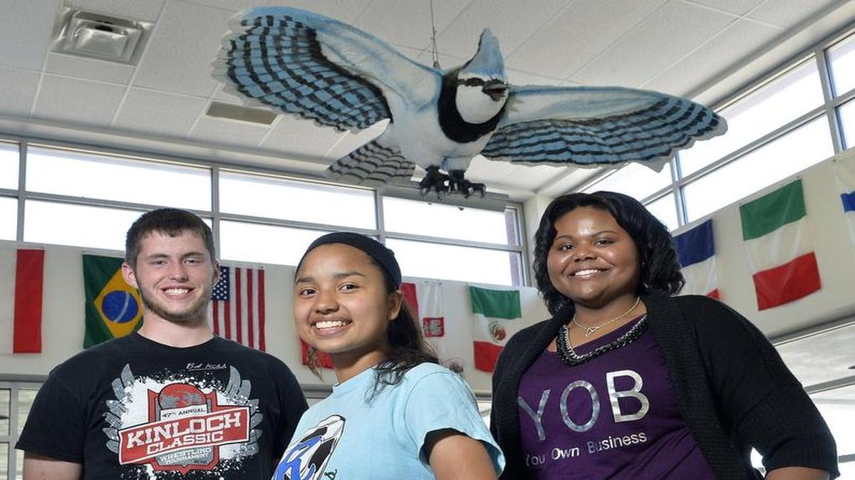 
Having just completed the ACT test Tuesday, Raytown High School juniors Derek Frazier (from left), Viviana Olvera and Destiny Gee posed below the school’s mascot, the bluejay.
