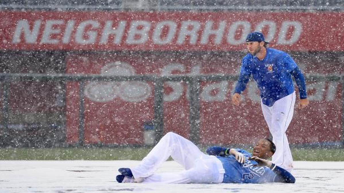 
The Royals’ Mike Moustakas (standing) and Alcides Escobar played in the snow-covered infield tarp after the game against the Tampa Bay Rays was canceled on May 2, 2013, at Kauffman Stadium.
