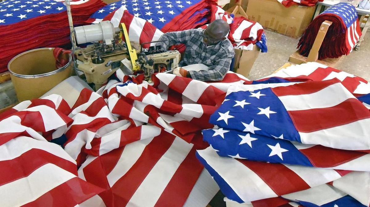 Amadou Sy sewed American flag stripes together at Allied Flag in Kansas City.