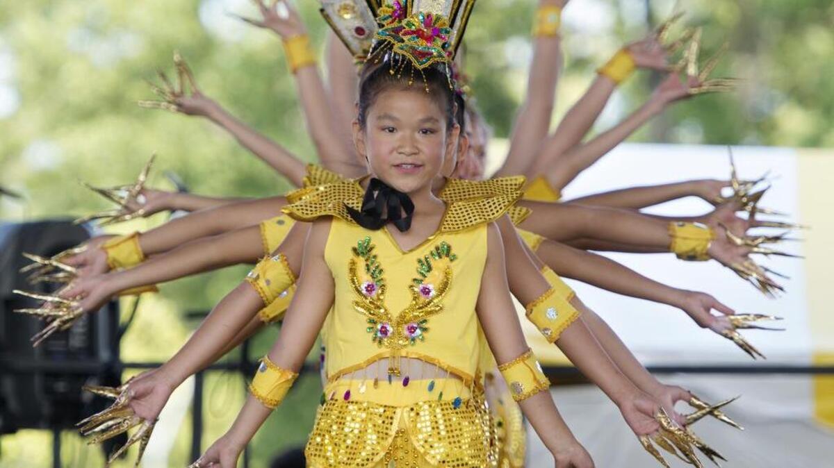 
Savannah Williams was leading the beginning portion of the Thousand Hands Dance as members of the Lily Zhang Li Taylor Dance Academy performed for the crowd Saturday during the Ethnic Enrichment Festival at Swope Park in Kansas City.
