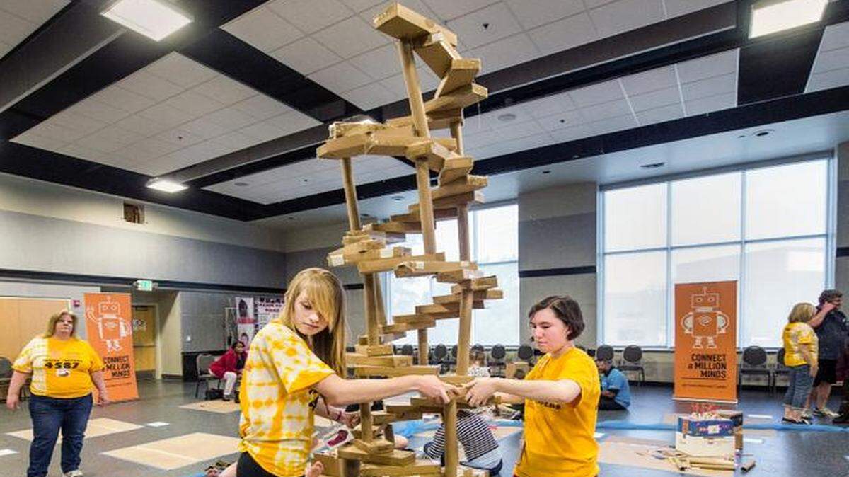 
Learn Science & Math Club members Isabelle McCann (left), 14, and Anna Baker, 15, moved the spiral staircase they created from recycled materials at the group’s City Imagineerium event Saturday, at the Atterbury Student Success Center at the University of Missouri-Kansas City. 
