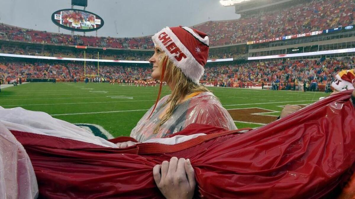 Amber Durr, from Hamburg, Iowa, holds onto the American Flag before helping display it for the National Anthem during Sunday's football game between the San Diego Chargers and Kansas City Chiefs on Sunday at Arrowhead Stadium in Kansas City.