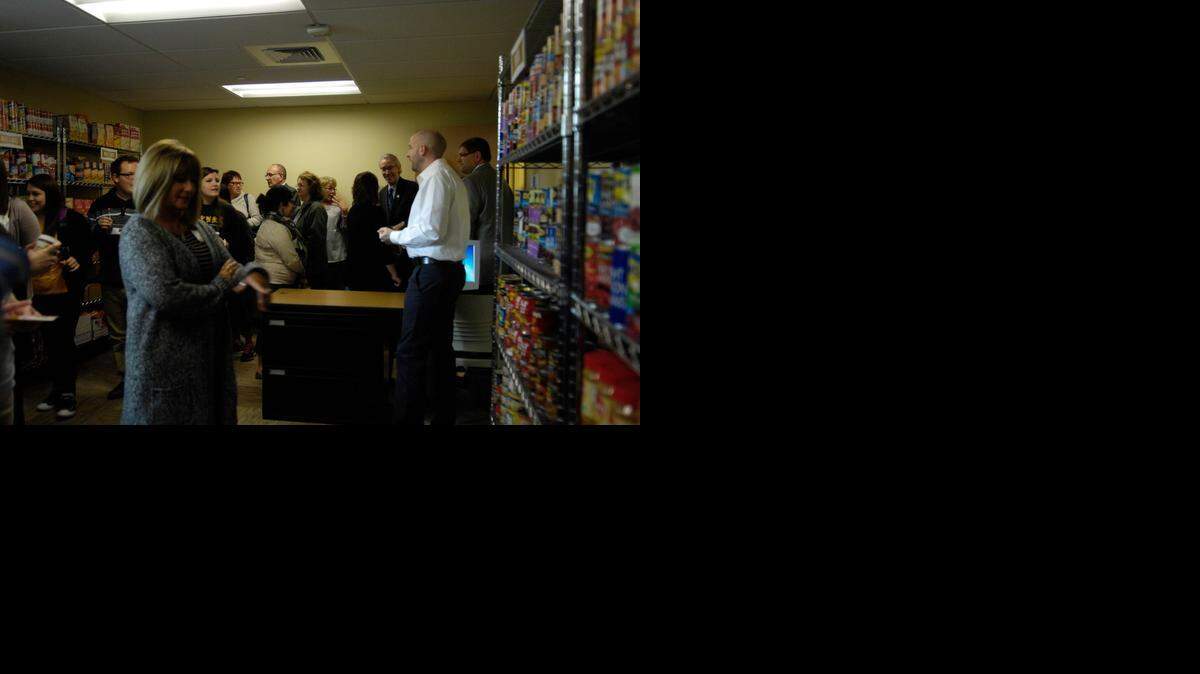 
Jason Bosch (right, in white shirt), director of the Center for Student Involvement at Emporia State, spoke to students and others at the opening of a campus food pantry. 
