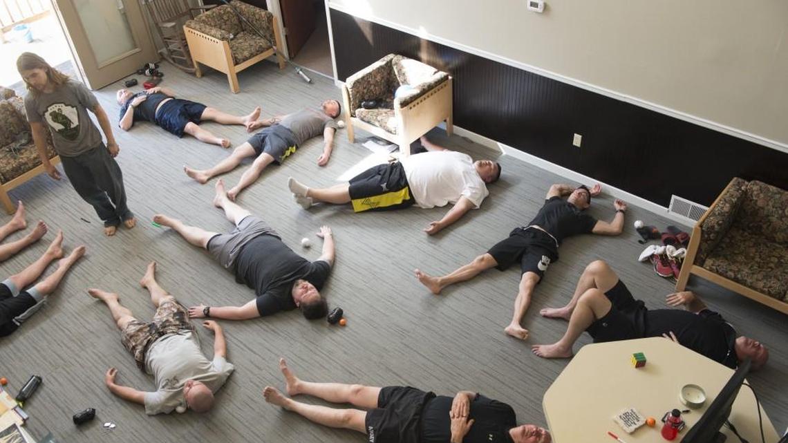 In this file photo, Thomas Thatcher (upper left) of Crossfit Lawrence worked with veterans on techniques for muscle relaxation, strengthening and yoga during the Save A Warrior program that helps veterans with suicide prevention. Last month, researchers at Washington University School of Medicine announced they were studying laughing gas as a treatment for suicidal thoughts.
