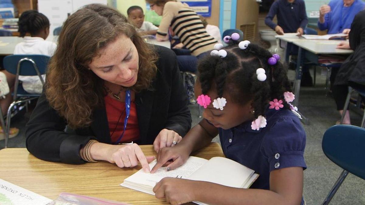 
Lead to Read volunteer Lynn Carlton and her reading buddy Shamarian crack open “Charlotte's Web” at Wendell Phillips Elementary School, 1619 E. 24th Terrace in Kansas City.
