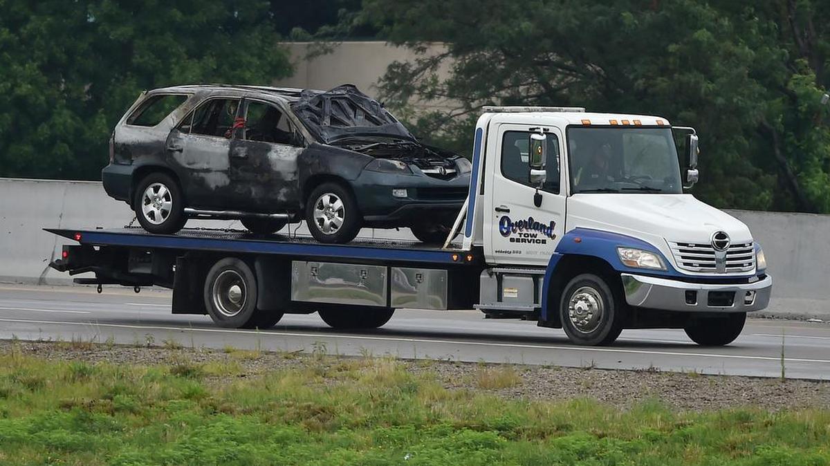 
A burned vehicle was loaded on a truck Wednesday morning on the ramp off of southbound Interstate 35 to U.S. 69. Police were on the scene to investigate after body was found at the scene. The early morning incident backed up traffic along I-35 for hours.

