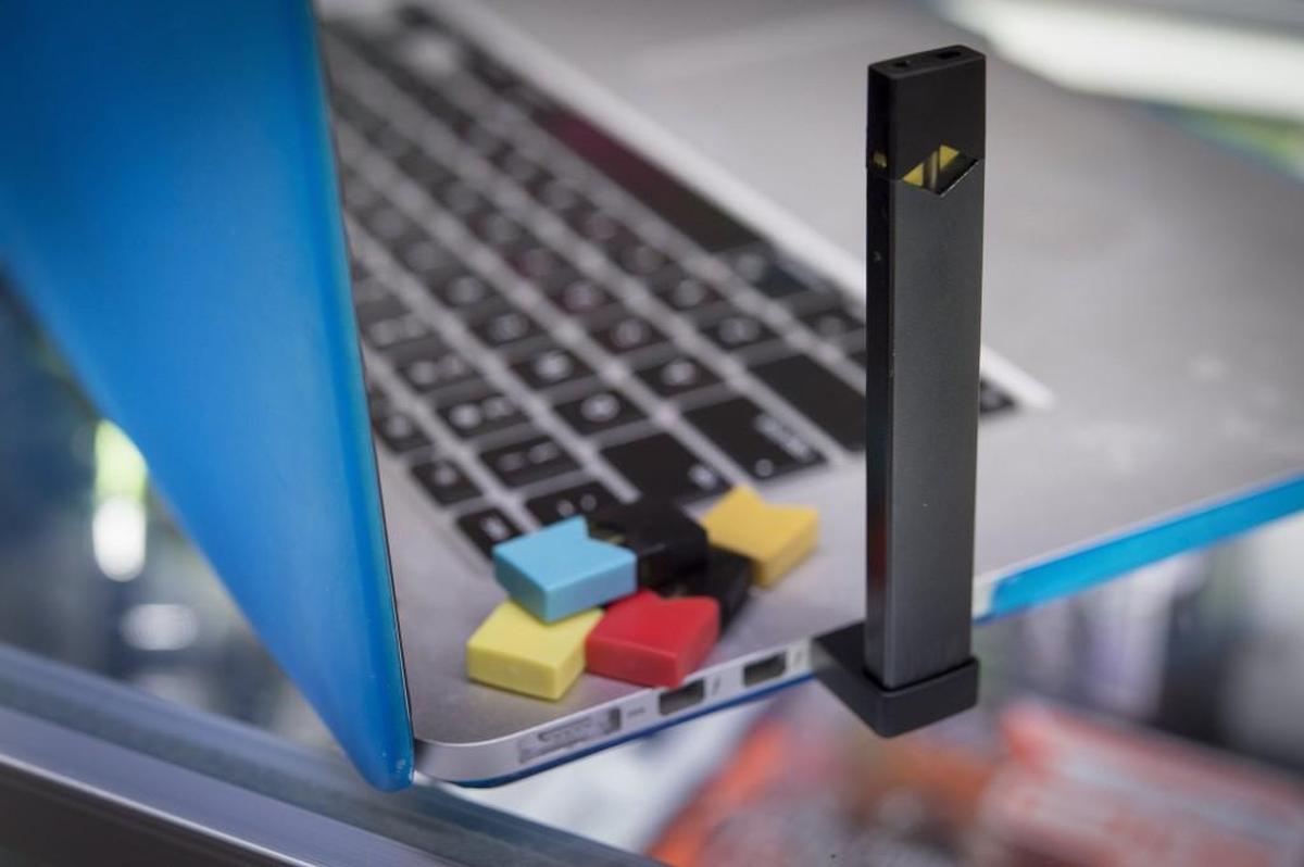 A Juul electronic cigarette can be plugged into a USB port on a laptop.