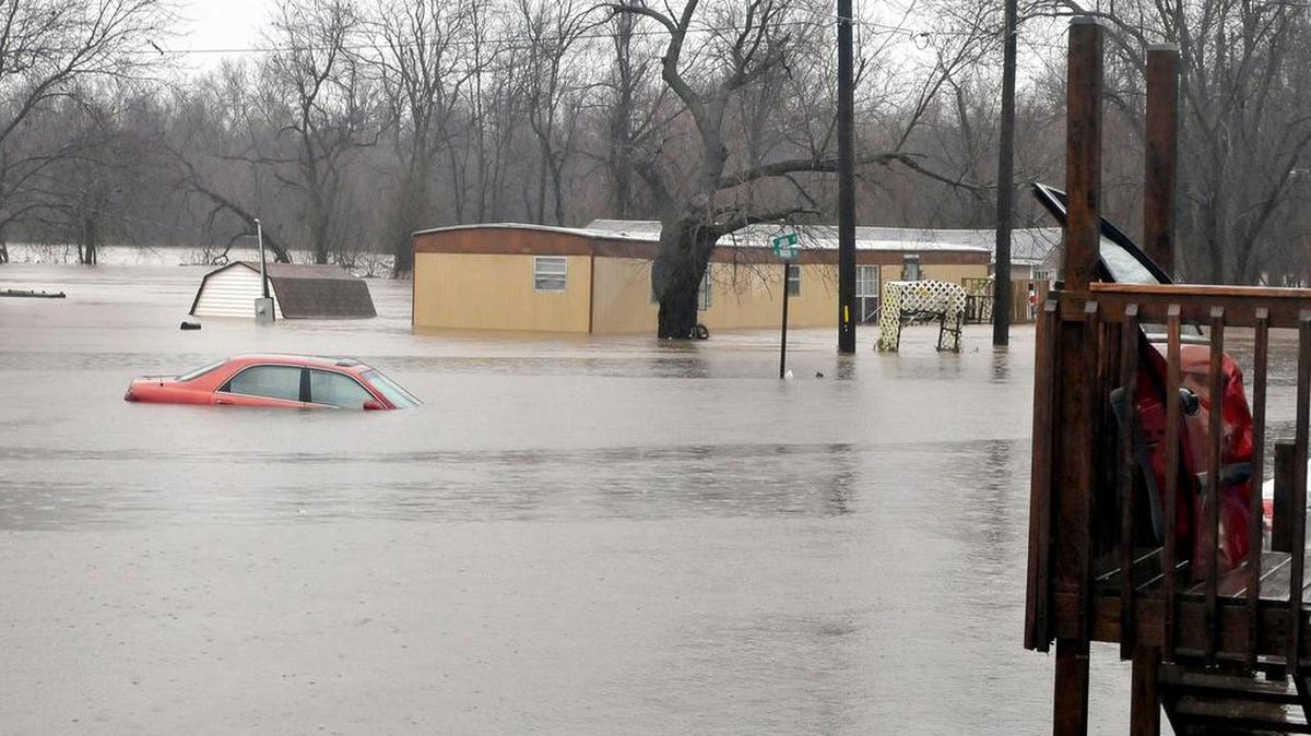 Spring river floods homes in Kendricktown, Mo., Sunday, Dec. 27, 2015. Missouri's governor has declared a state of emergency because of widespread flooding that has led to multiple fatalities.