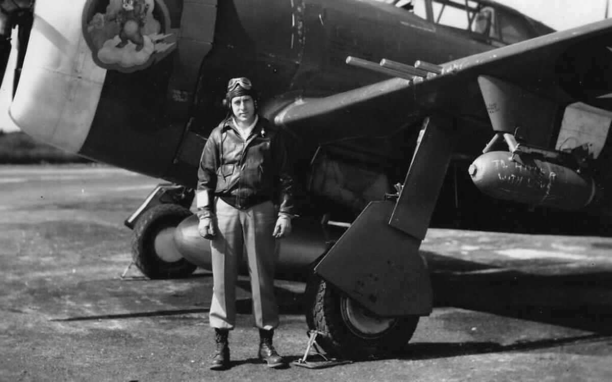 Henry Quimby with his fighter, a P-47 Thunderbolt. The message on the bomb: “To Hitler with love.”