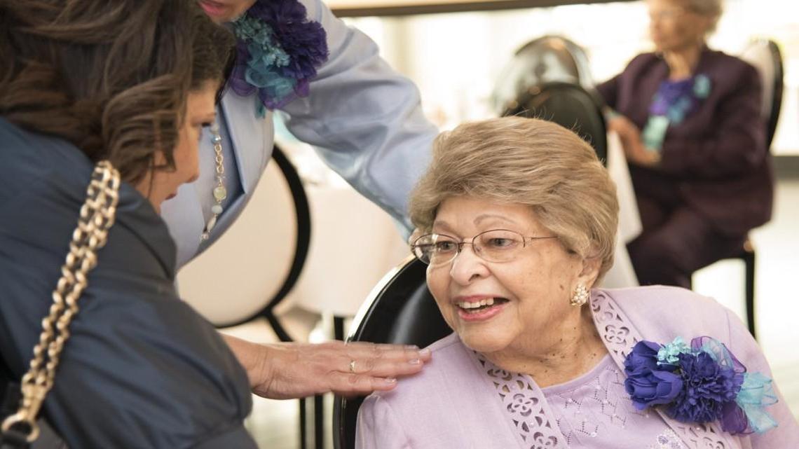 Mila L. Banks, 102 years old and a founding member of the Saturday Night Sixteen Club, was greeted by well-wishers Rose Jones and her sister Donna Fowler. The social club for African-American women celebrated its 70th anniversary Saturday at the Grand Street Cafe, 4740 Grand Ave.